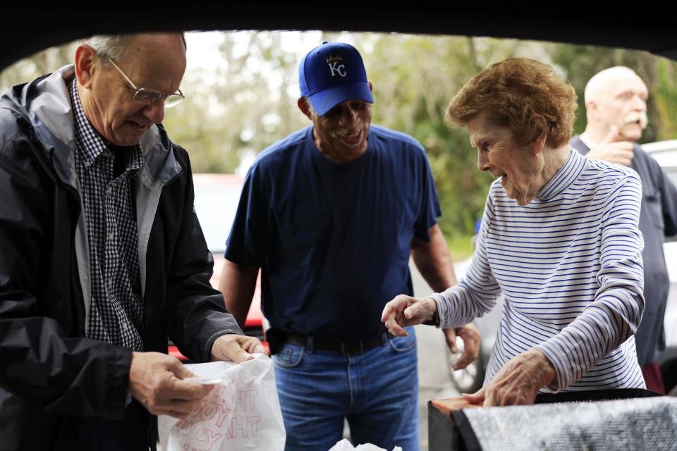 Mary Alice Wolfe smiles with the Rev. David MacFarland, left, and Lee Waddell, during a delivery in Hastings. Wolfe, 93, has been helping deliver food to needy seniors in St. Johns County since 2001 through her Christ United Methodist Church and Pie in the Sky nonprofit. “It gives me some reason to get up in the morning, get going, instead of just sitting around. These people need it … as long as I can, I’ll keep on," the retired longtime teacher said.