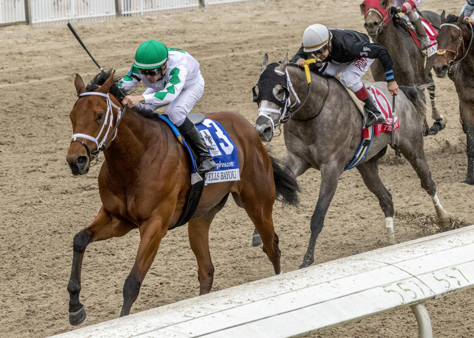 Wells Bayou, ridden by jockey Florent Geroux, wins the 107th running of the $1,000,000 Grade II Louisiana Derby horse race, Saturday, March 21, 2020, at a fanless Fair Grounds race course in New Orleans. (Amanda Hodges Weir/Hodges Photography, Fair Grounds Race Course via AP)
