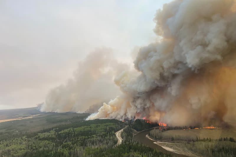 A smoke column rises from wildfire EWF-035 near Shining Bank