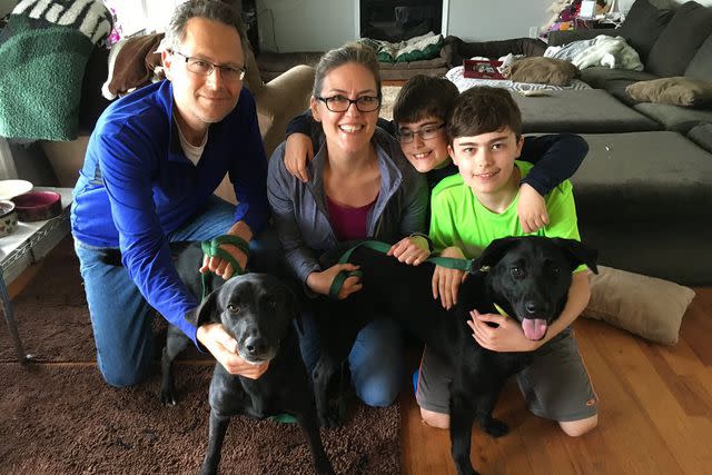 <p>Courtesy of the Wexton family</p> An old family photo of Jennifer Wexton with her husband, sons and rescued Labrador retrievers
