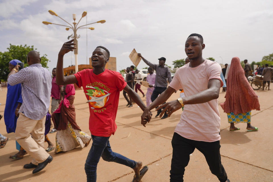 Supporters of Niger's ruling junta cheer in Niamey, Niger, Sunday, Aug. 6, 2023. Nigeriens are bracing for a possible military intervention as time's run out for its new junta leaders to reinstate the country's ousted president. (AP Photo/Sam Mednick)