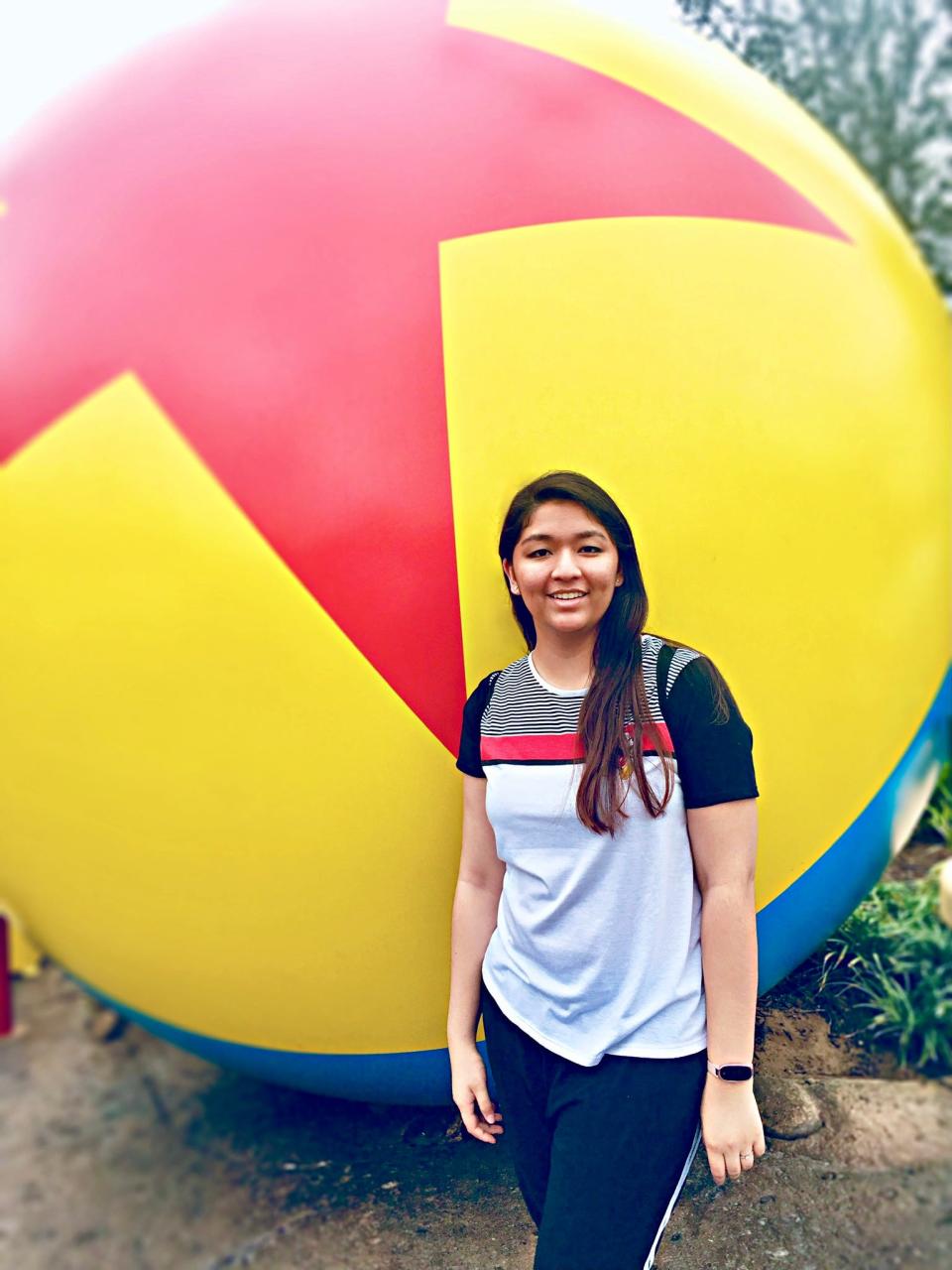 saira standing in front of the pixar ball at hollywood studios disney world