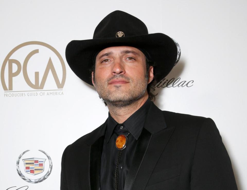 FILE - This Jan. 26, 2013 file photo originally released by The Producers Guild shows Robert Rodriguez during the cocktail reception at the 24th Annual Producers Guild (PGA) Awards in Beverly Hills, Calif. Univision announced Tuesday, May 14, 2013, it has made a strategic investment in El Rey Network created by Rodriguez. The network will launch in December 2013 and have nation-wide distribution with initial carriage via Comcast. (AP Photo/The Producers Guild, Todd Williamson, file)