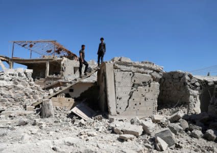 FILE PHOTO: Men inspect a damaged house in Busra al-Harir town, near Deraa, Syria March 13, 2018. REUTERS/Alaa al-Faqir/File Photo