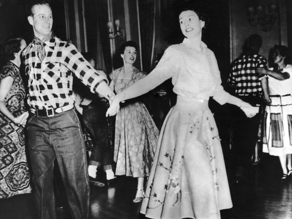 Queen Elizabeth and Prince Philip square dancing in 1951.