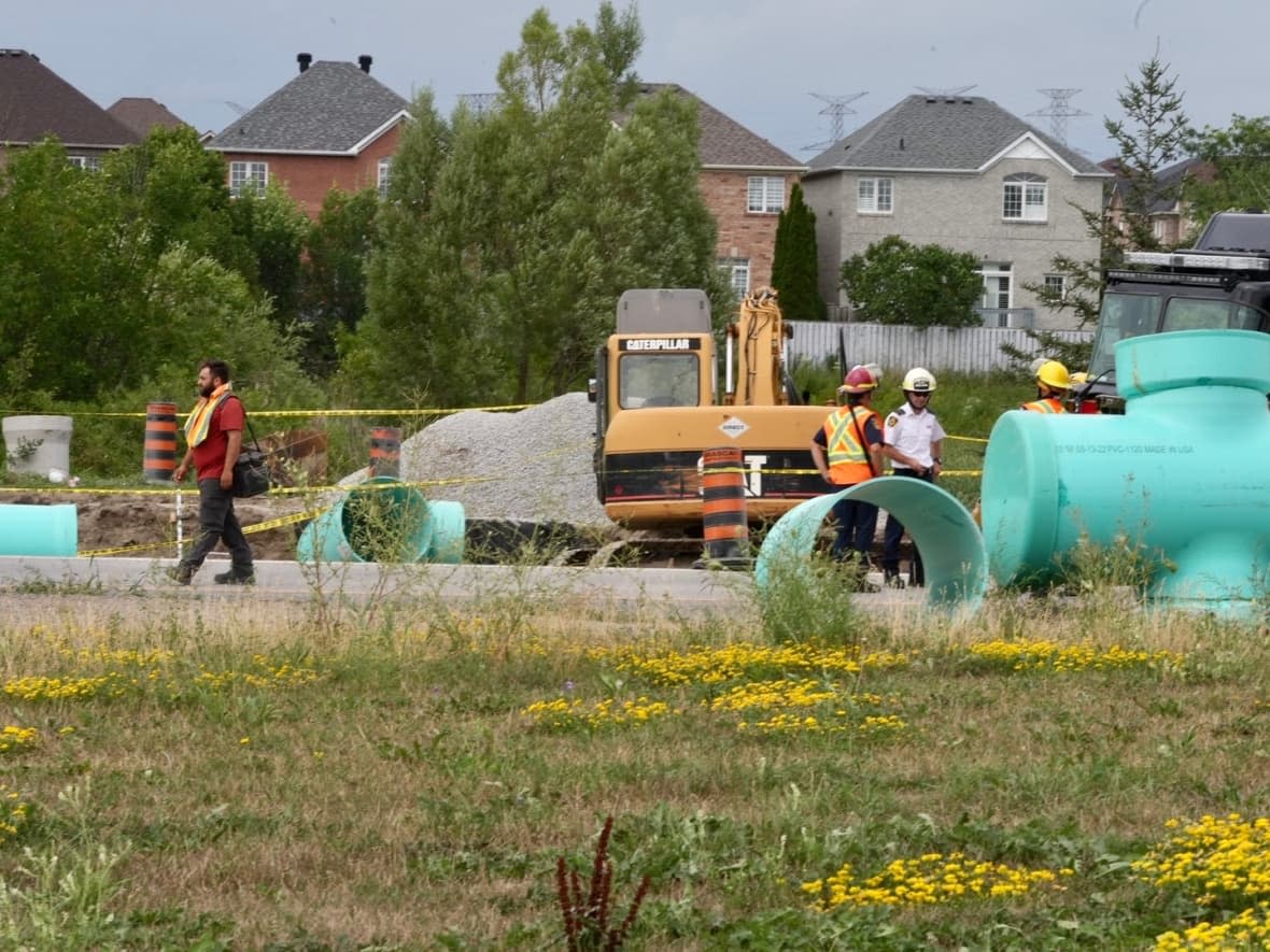 Durham Regional Police say the bodies of two workers have been recovered at a construction site in Ajax at 2:30 a.m. on Tuesday after 'extensive recovery efforts.'   (Martin Trainor/CBC - image credit)