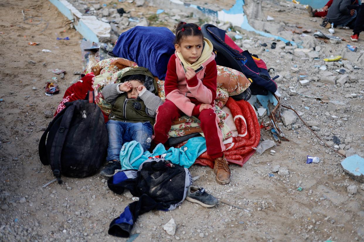 Children rest outside, as Palestinian arrive in Rafah after they were evacuated from Nasser hospital in Khan Younis (REUTERS)