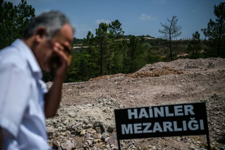 A sign reading "Traitors' Cemetery" is seen in front of unmarked graves built for soldiers who participated in the failed coup, on July 28, 2016 in Istanbul