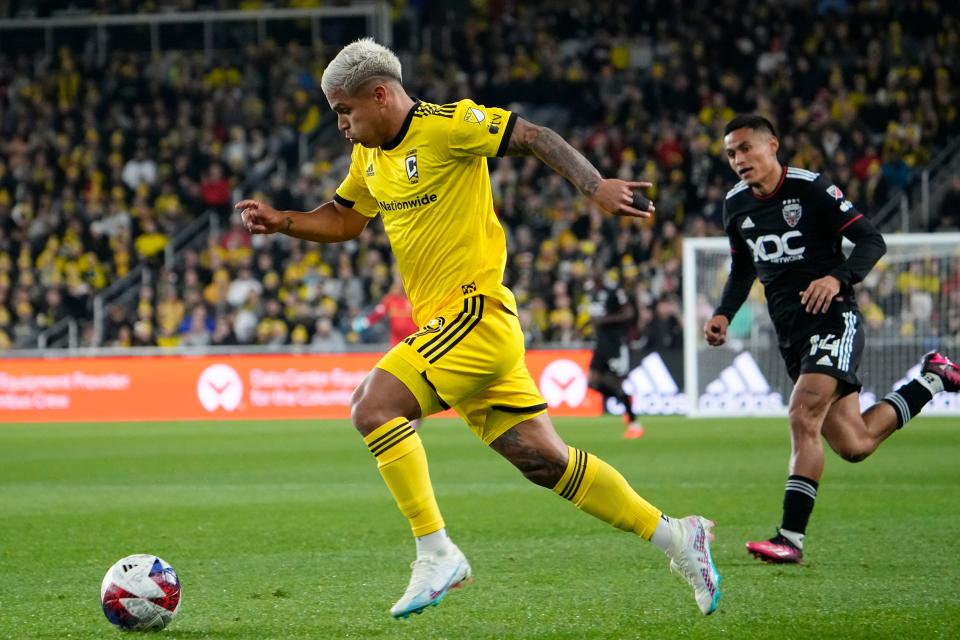 Mar 4, 2023;  Columbus, Ohio, USA;  Columbus Crew forward Cucho Hernandez (9) moves the ball upfield past DC United midfielder Andy Najar (14) during the MLS soccer match at Lower.com Field.  Mandatory Credit: Adam Cairns-The Columbus Dispatch