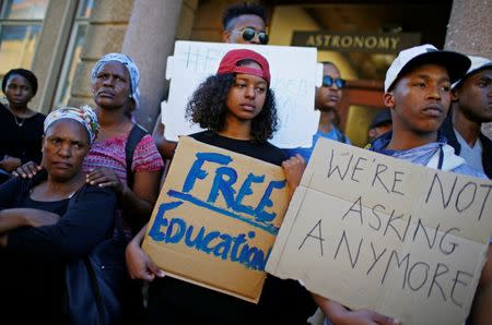 University of Cape Town (UCT) students hold placards during protests demanding free tertiary education in Cape Town. REUTERS/Mike Hutchings