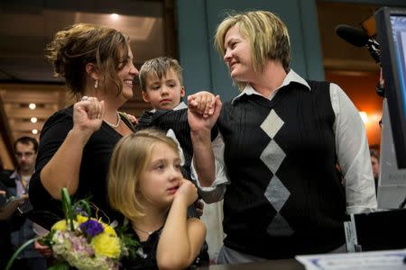 Kelley Harris (L) and her partner of 13 years, Kelly Barnard, apply for a marriage license with their son, Cooper Harris, and daughter, Mackenzie Harris, at City Hall in St. Louis, Missouri November 5, 2014. REUTERS/Whitney Curtis