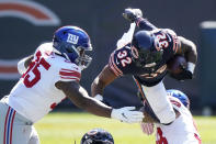 Chicago Bears running back David Montgomery (32) is brought down by New York Giants nose tackle Austin Johnson (98) as defensive end B.J. Hill (95) assists during the first half of an NFL football game in Chicago, Sunday, Sept. 20, 2020. (AP Photo/Nam Y. Huh)