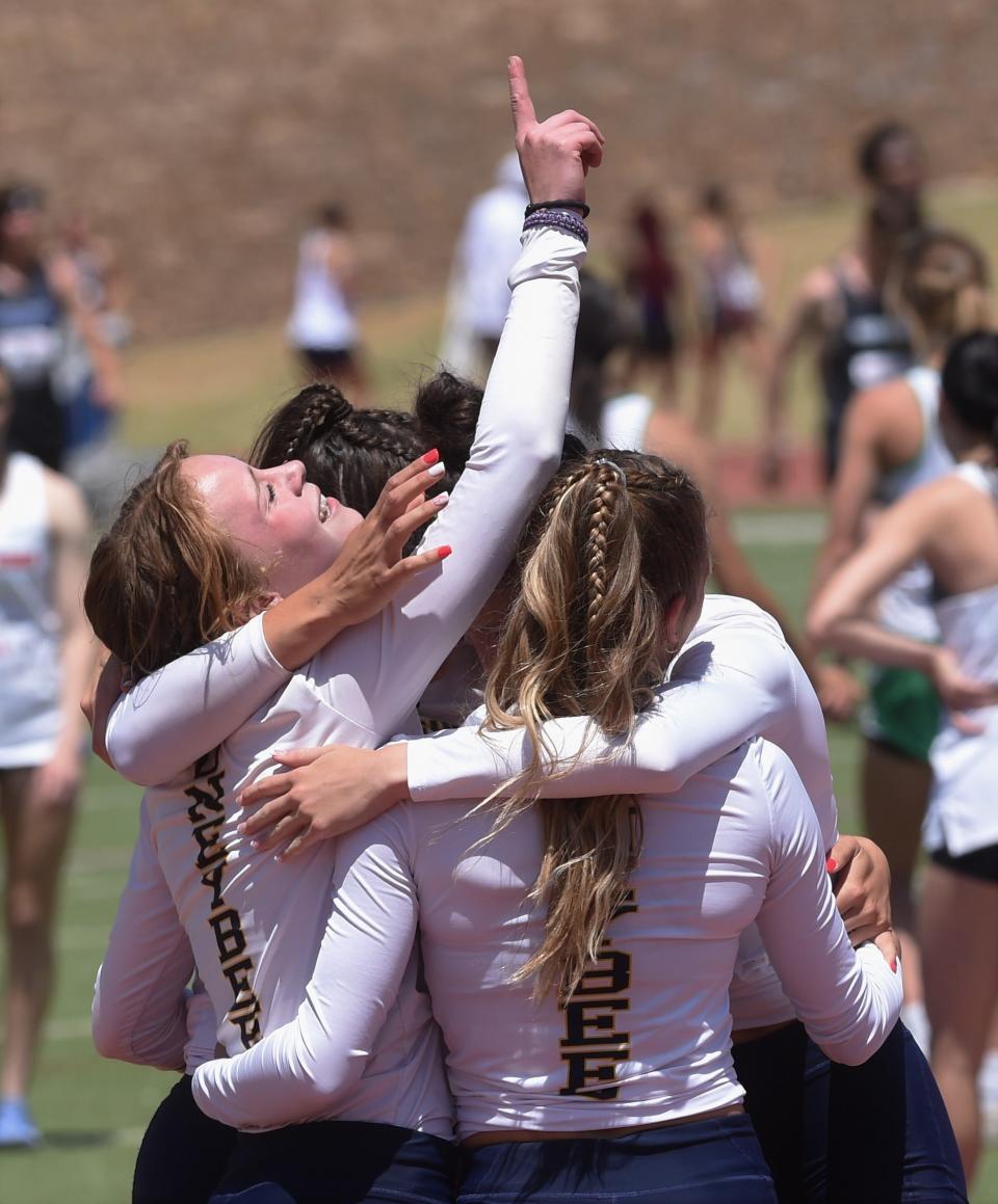 Stephenville's Victoria Cameron signals No. 1 while teammates Jaylee Matthews, Reese Weyers and Marin Copeland embrace her after winning the 400 relay at the Region I-4A track and field meet Saturday, April 30, 2022, at Lowrey Field.