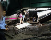 <p>People examine the wreckage of a New Jersey Transit commuter train that crashed into the train station during the morning rush hour in Hoboken,, N.J., Thursday, Sept. 29, 2016. (William Sun via AP) </p>