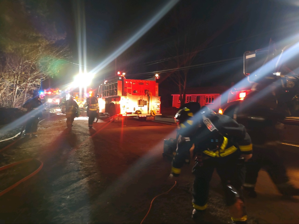 Firefighters respond to a fire at a home in Arundel, Maine, in the early hours of Sunday, March 19, 2023.