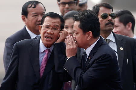 Cambodia's Prime Minister Hun Sen (L) talks to an official after arriving at Air Force Station Palam in New Delhi, India, January 24, 2018. REUTERS/Adnan Abidi