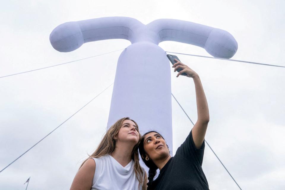 Hannah Tuohy and Meghan Ravi with the group, Americans for Contraception, take a selfie in front of an inflatable IUD on Capitol Hill on June 5, 2024 (REUTERS)