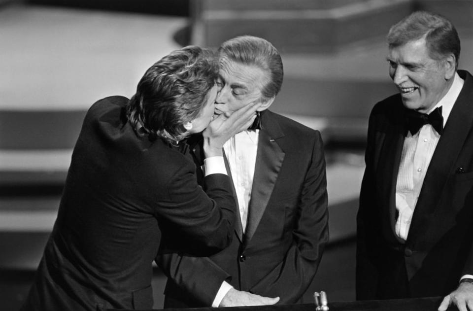 <div class="inline-image__title">106569629</div> <div class="inline-image__caption"><p>"US actor Michael Douglas (L) kisses his father US actor Kirk Douglas (C) next to actor Burt Lancaster (R) during the 57th Annual Academy Awards, on March 25, 1985, in Hollywood, California. AFP PHOTO ROB BOREN (Photo credit should read ROB BOREN/AFP/Getty Images)"</p></div> <div class="inline-image__credit">ROB BOREN</div>