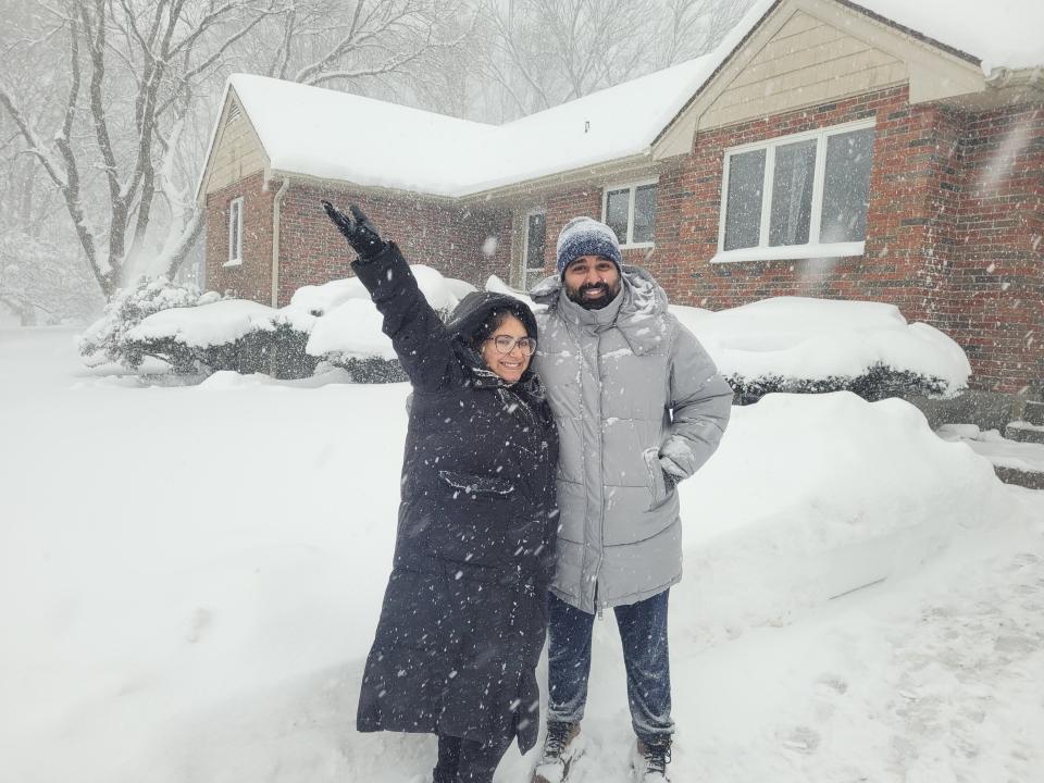 Faiz Sobhani, 30, and his wife, Sanaa, outside their Modoc Street home in Worcester Sunday afternoon. Faiz, who immigrated to the U.S. three months ago from India, had never seen snowfall until Sunday. "Pure bliss," he said.
