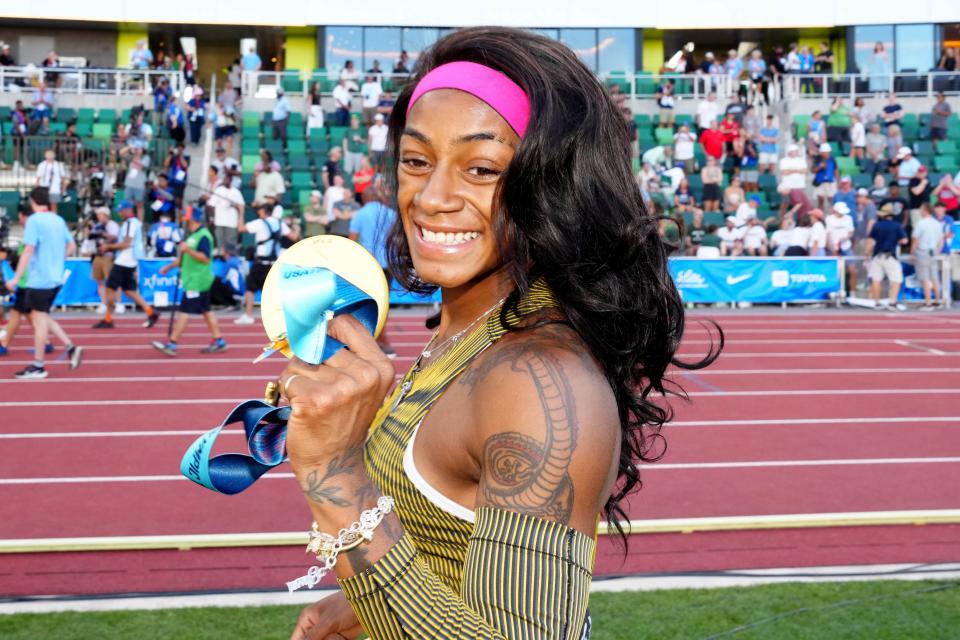 Sha'Carri Richardson poses with gold medal after winning the women's 100m in 10.70 during the US Olympic Team Trials at Hayward Field.