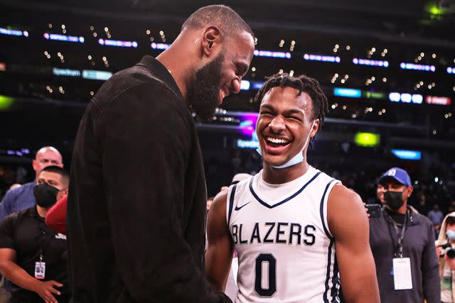 Jason Armond/Los Angeles Times via Getty Lebron James comes onto the court to congratulate his son Bronny James (0) point guard for Sierra Canyon after his team won against St. Vincent-St. Mary during The Chosen - 1's Invitational High School Basketball Showcase at the Staples Center on Saturday, Dec. 4, 2021 in Los Angeles, CA.