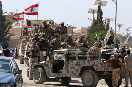 Lebanese army soldiers are seen on their military vehicles in the town of Ras Baalbek, Lebanon August 21, 2017. REUTERS/ Ali Hashisho