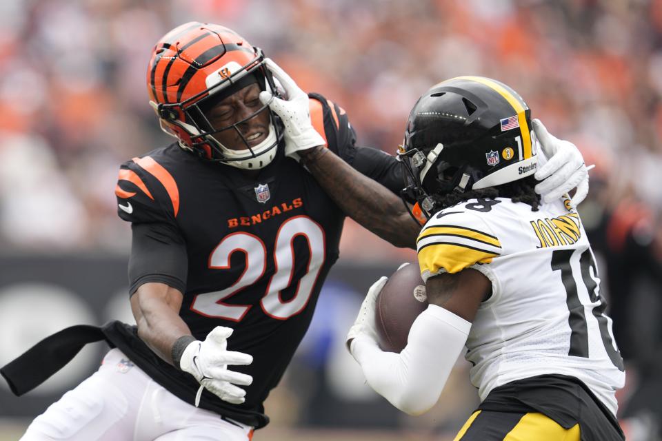 Pittsburgh Steelers wide receiver Diontae Johnson (18) is tackled by Cincinnati Bengals cornerback Eli Apple (20) during the first half of an NFL football game, Sunday, Sept. 11, 2022, in Cincinnati. (AP Photo/Jeff Dean)