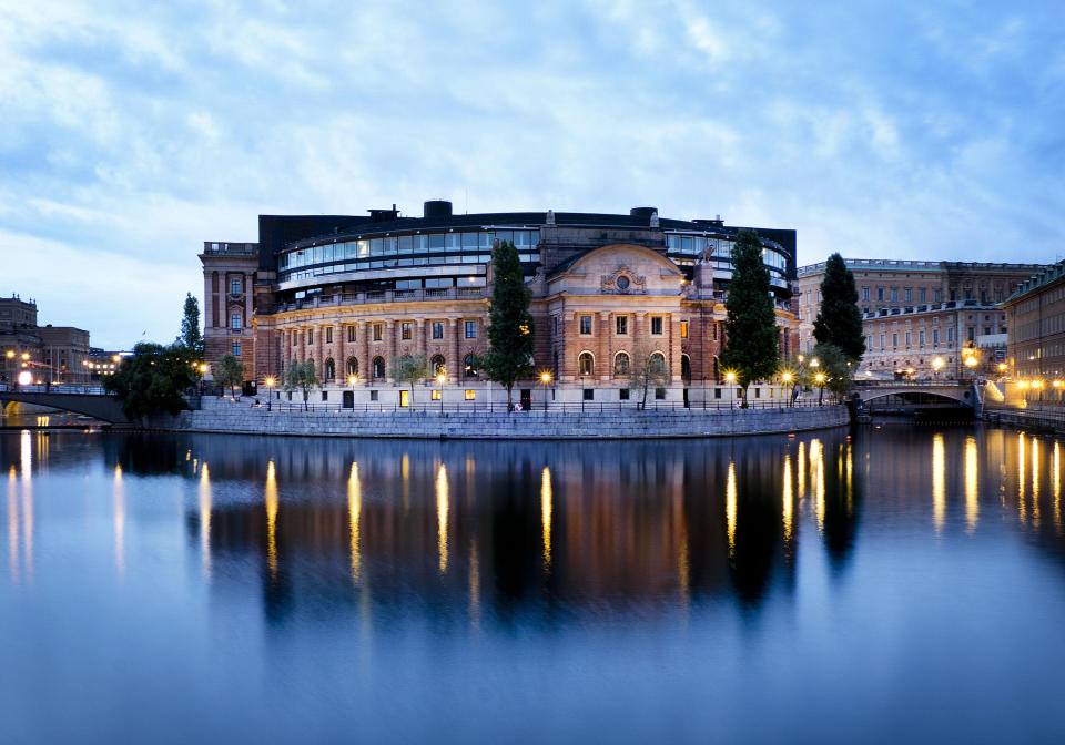 In this Aug. 30, 2018 the back side of the Swedish parliament is reflected in the water in Stockholm, Sweden. (AP Photo/Michael Probst)