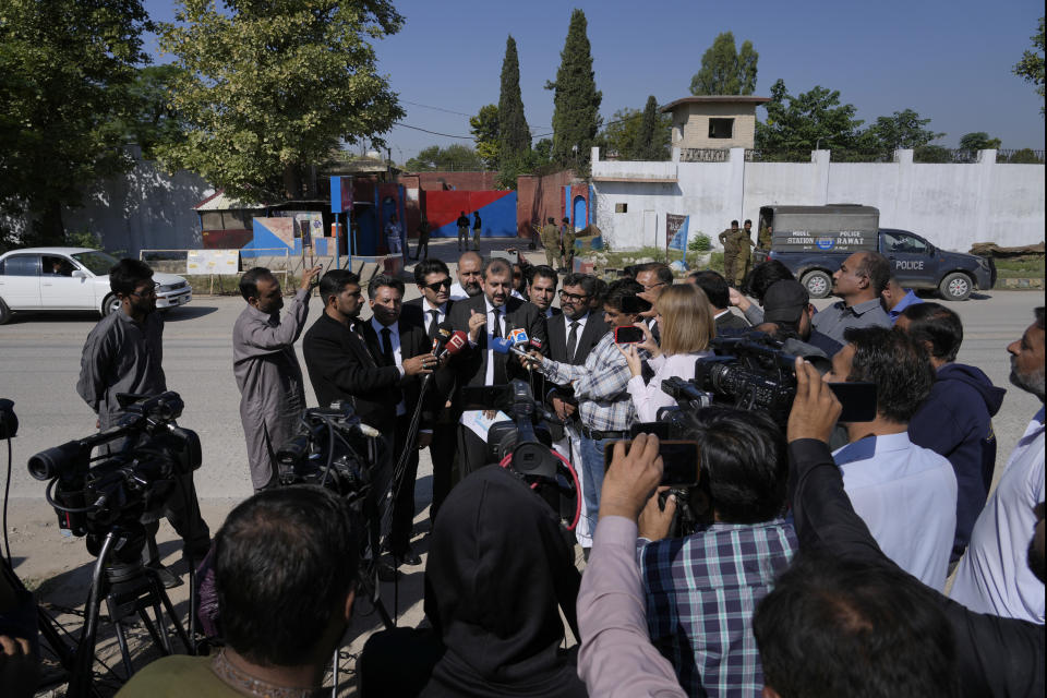 Umair Niazi, center, a lawyer of Pakistan former Prime Minister Imran Khan's legal team, talks to media members after a special court hearing of the Cipher case against Khan, outside the Adiyala prison, in Rawalpindi, Pakistan, Monday, Oct. 23, 2023. A Pakistani court on Monday indicted Khan on charges of revealing official secrets after his 2022 ouster from office in another slap to the former prime minister who will likely be unable to run in the upcoming parliamentary elections in late January. (AP Photo/Anjum Naveed)