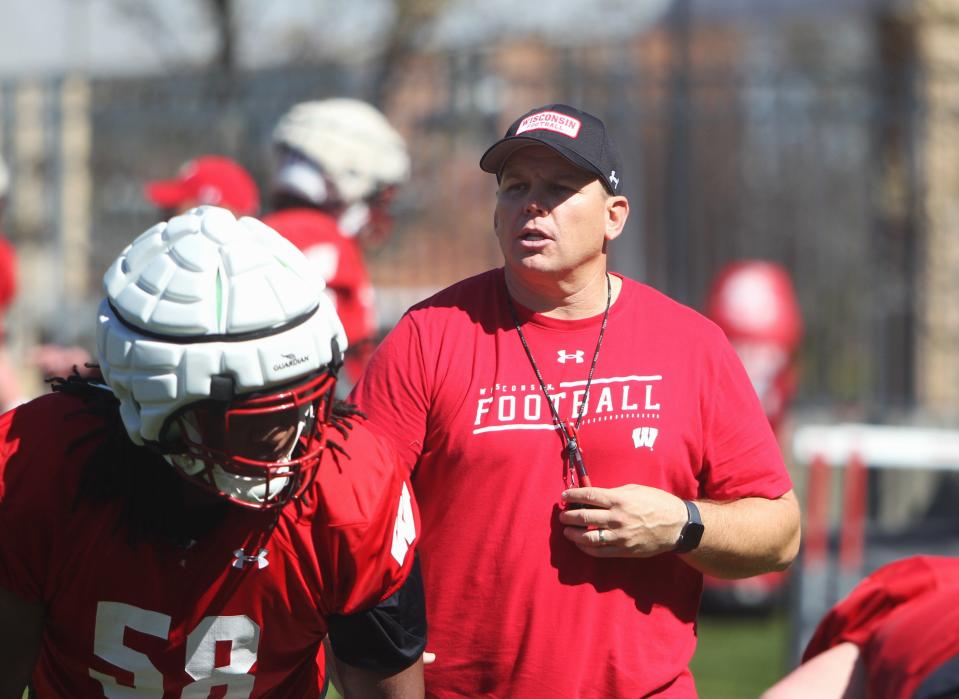 Wisconsin offensive line coach AJ Blazek works with Manny Mullens during a practice earlier this month. Blazek is dealing with a glaring lack of depth on the Badgers' line this spring.