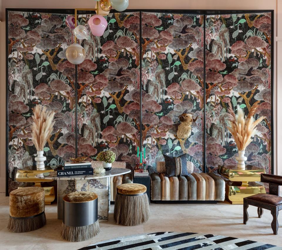 An imposing screen covered in a patterned wallcovering by Arte makes a strong visual statement in the living room designed by Marc-Michaels Interior Design for the latest Kips Bay Decorator Show House Palm Beach.