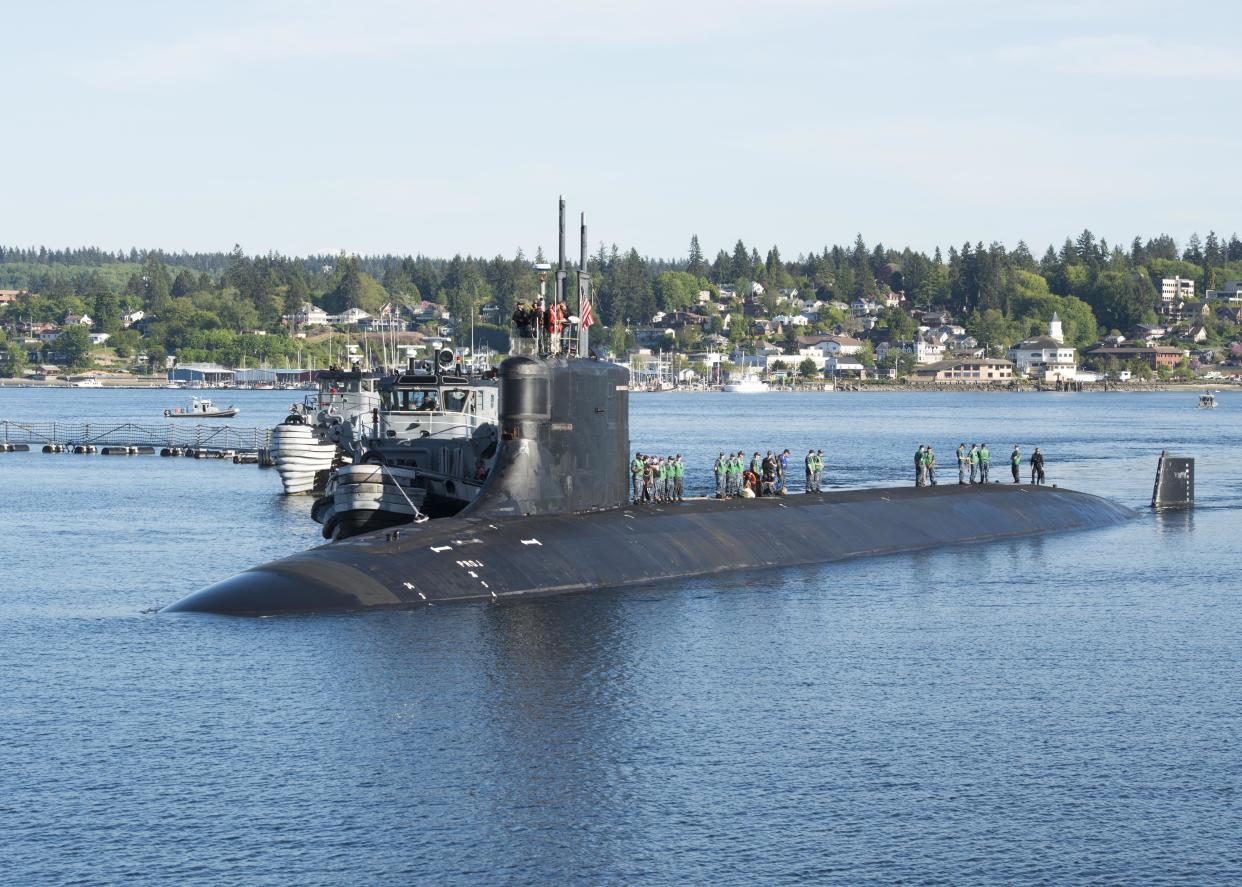 Photograph of submariners standing on top of the Seawolf-class fast-attack submarine USS Connecticut in the water at Naval Base Kitsap-Bremerton, Washington, May 7, 2018. (Photo by Smith Collection/Gado/Getty Images)