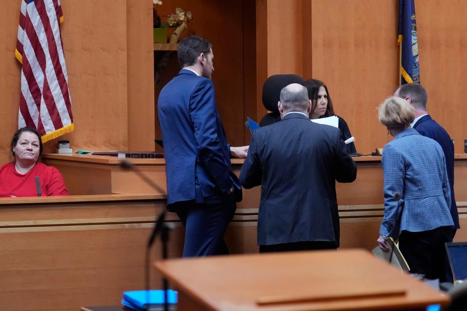 Judge Amy Messer, seated at right, listens to defense and prosecution attorneys as witness Rebecca Maines, left, waits on the witness stand during the trial of the Adam Montgomery at Hillsborough County Superior Court, Tuesday, Feb. 20, 2024, in Manchester, N.H. Montgomery is facing second-degree murder and other charges in the death of his daughter, Harmony. (AP Photo/Charles Krupa, Pool)