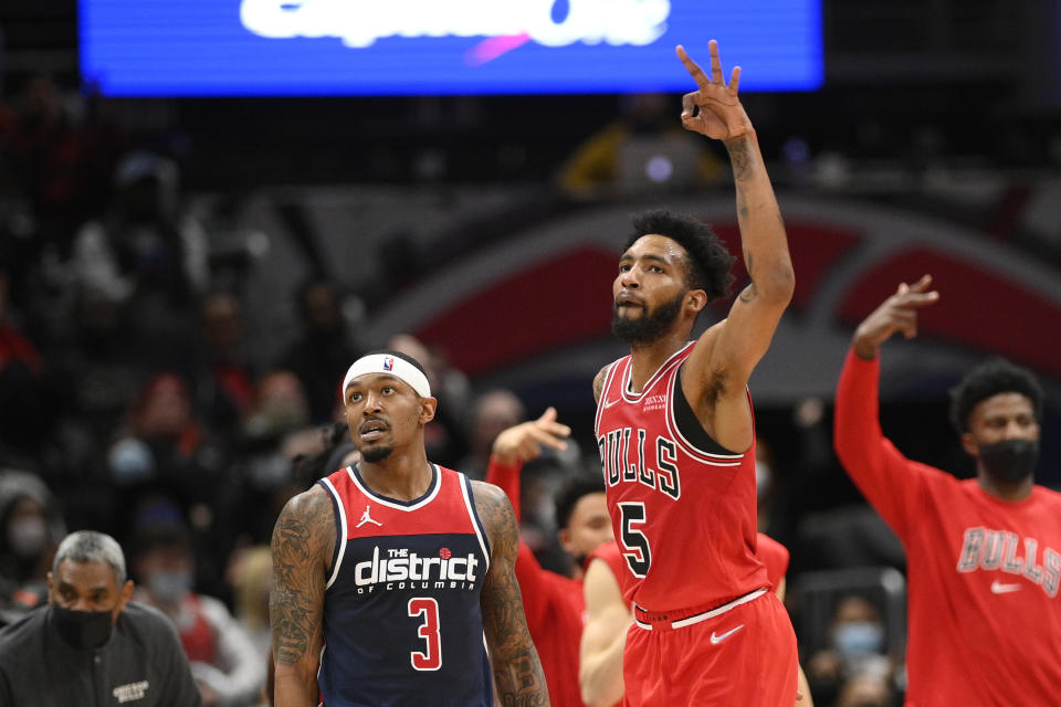 Chicago Bulls forward Derrick Jones Jr. (5) reacts next to Washington Wizards guard Bradley Beal (3) after he made a three-point basket during the second half of an NBA basketball game, Saturday, Jan. 1, 2022, in Washington. The Bulls won 120-119. (AP Photo/Nick Wass)