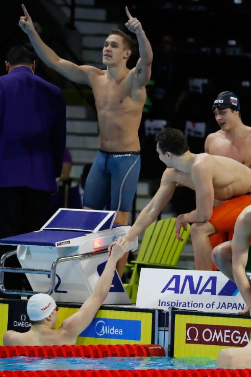 Team Russia celebrate their victory in the 4x50m freestyle final during the 13th FINA Short Course World Swimming Championships, in Windsor, Ontario, Canada, on December 9, 2016