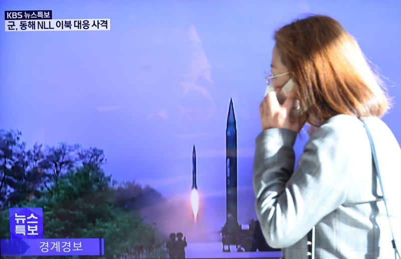 Una mujer pasa junto a una pantalla de televisión que emite una noticia sobre el lanzamiento de un misil balístico por parte de Corea del Norte frente a su costa oriental, en Seúl, Corea del Sur