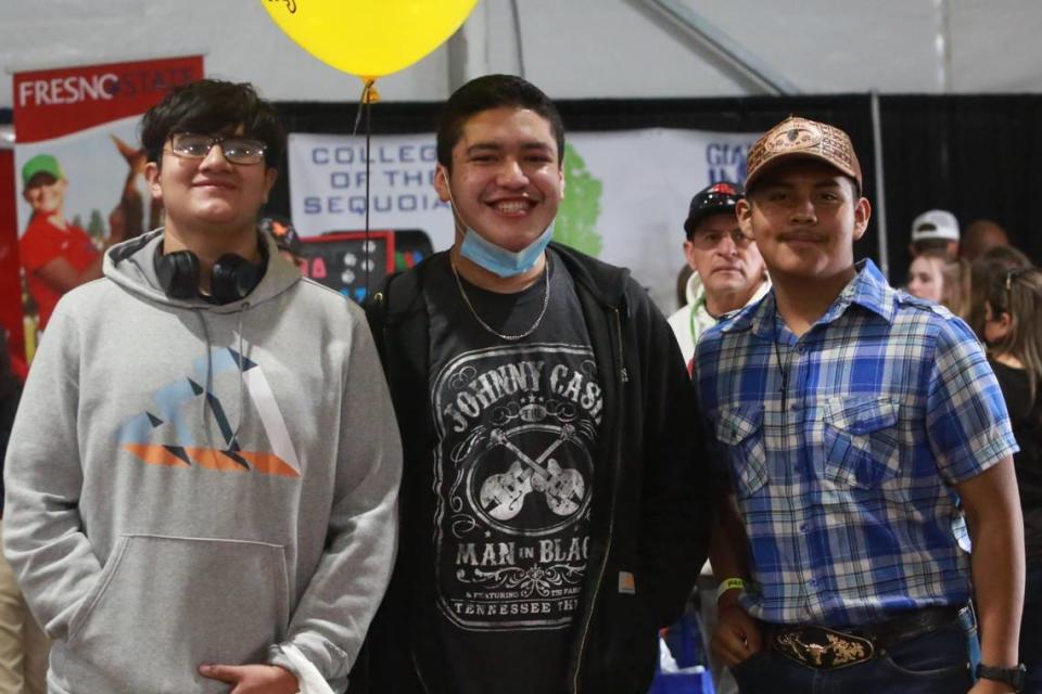 Mendota High School students Edgar Larreynaga, Jesús Figueroa, Tomas Pérez, walked around the Ag Career and Education tent at the World Ag Expo on Tuesday, Feb. 8, 2022, stopping at different college booths including California State Polytechnic University, Pomona, and Stanislaus State. 