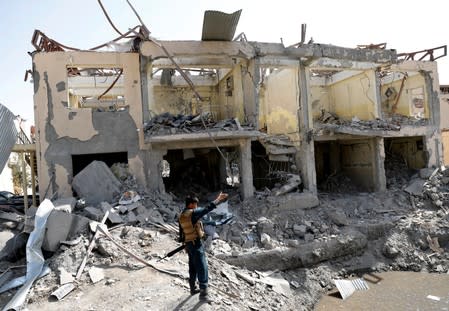 An Afghan police officers inspects the site of a blast in Kabul