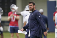 Tennessee Titans offensive coordinator Tim Kelly walks across the field during practice at the NFL football team's training facility Wednesday, June 7, 2023, in Nashville, Tenn. (AP Photo/George Walker IV)