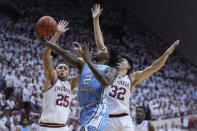 CORRECTS CITY TO BLOOMINGTON, INSTEAD OF INDIANAPOLIS - North Carolina guard Caleb Love (2) drives to the basket against Indiana forward Race Thompson (25) and guard Trey Galloway (32) during the first half of an NCAA college basketball game in Bloomington, Ind., , Wednesday, Nov. 30, 2022. (AP Photo/Darron Cummings)