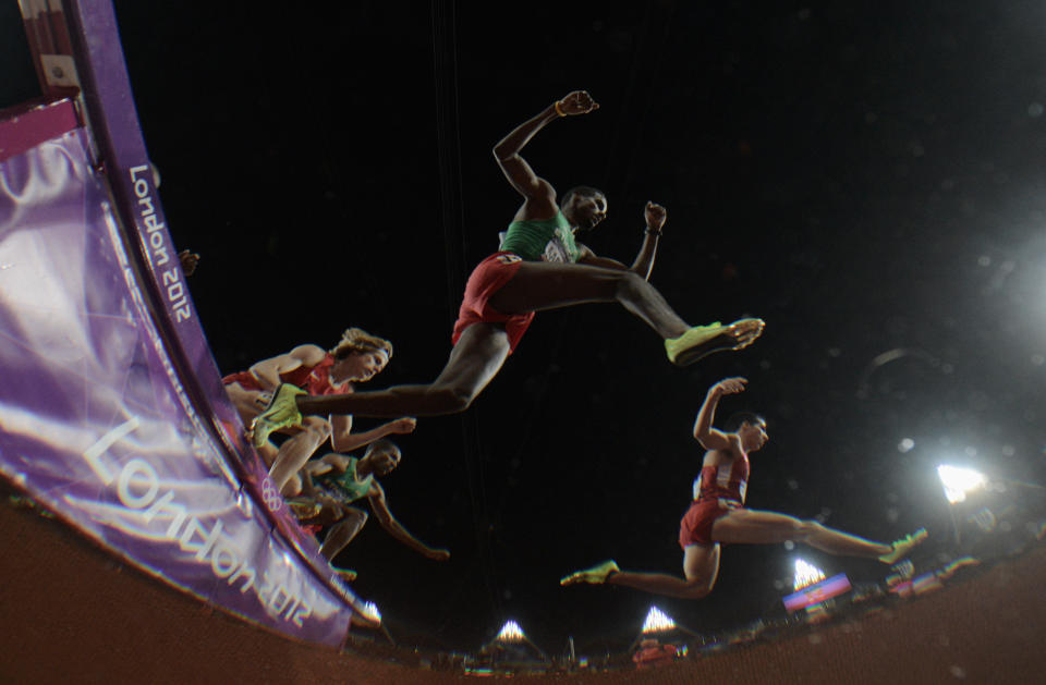 LONDON, ENGLAND - AUGUST 05: Athletes clear the water jump during the Men's 3000m Steeplechase Final on Day 9 of the London 2012 Olympic Games at the Olympic Stadium on August 5, 2012 in London, England. (Photo by Adam Pretty/Getty Images)