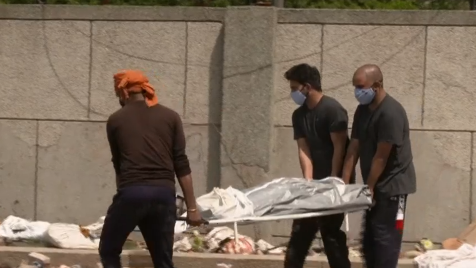 Volunteers in New Delhi collect bodies of those who died from COVID-19 and whose families could not afford cremation.  / Credit: CBS News