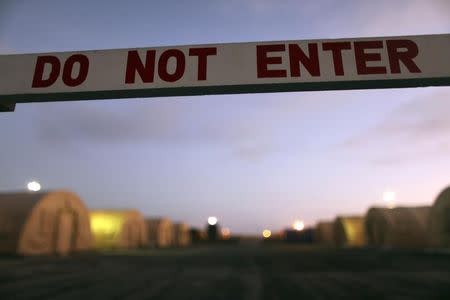 In this photo, reviewed by the U.S. Military, a sign marks a closed-off area, at Camp Justice, the location of the U.S. Military Commissions court for war crimes, at the U.S. Naval Base, in Guantanamo Bay, Cuba, January 19, 2009. REUTERS/Brennan Linsley/Pool