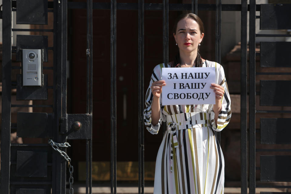 Ukrainian activist Oleksandra Matviichuk holds a placard which says “For Your and Our Freedom” as she protests in front of Russian Embassy against decision of Russian court to jail IT professional Konstantin Kotov, in Kyiv, Ukraine, on Sept. 5, 2019.