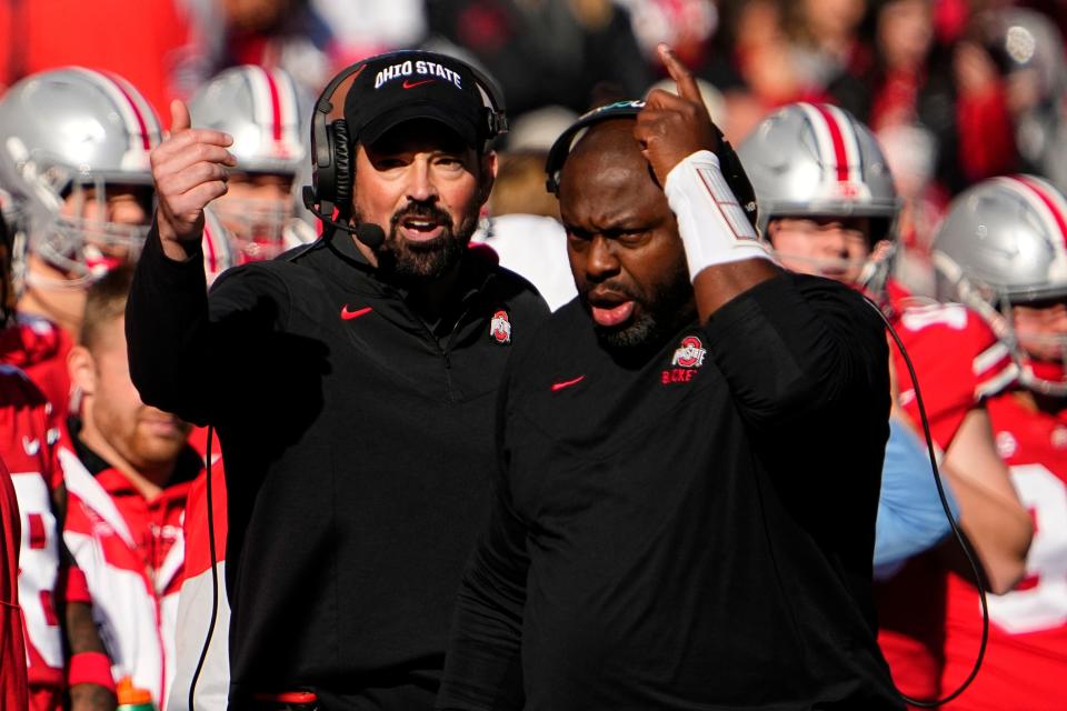 Nov 26, 2022; Columbus, Ohio, USA;  Ohio State Buckeyes head coach Ryan Day and running backs coach Tony Alford motion from the sideline during the first half of the NCAA football game against the Michigan Wolverines at Ohio Stadium. Mandatory Credit: Adam Cairns-The Columbus Dispatch