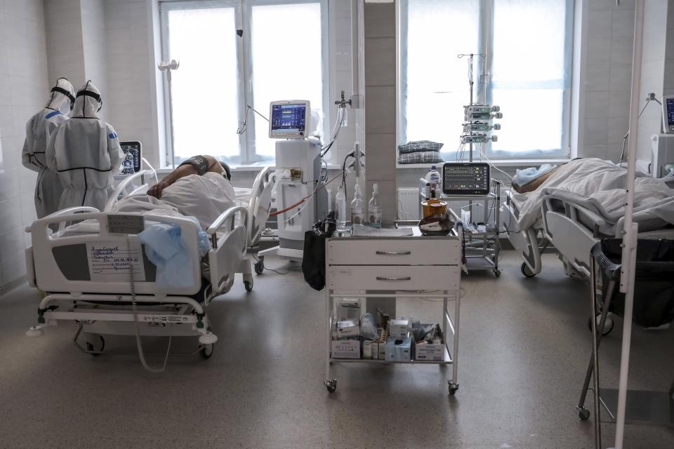 In this photo taken on Saturday, May 2, 2020, doctors attend to a patient inside the intensive care unit for people infected with the new coronavirus, at a hospital in Moscow, Russia. A Russian epidemiologist says the sharp increase in coronavirus infection cases recorded over the past week reflects increased testing. Russia on Sunday reported more then ten thousand new cases, nearly double the new cases reported a week ago and the first time the daily tally went into five digits.(AP Photo/Sophia Sandurskaya)