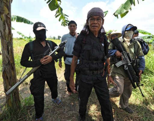 Ameril Umbrakato (C), leader of a breakaway Muslim separatist group, pictured here with his troops in Datu Unsay town, Maguindanao province, in August. Umbrakato, whose forces have threatened the peace efforts of the government, has fallen ill, a spokesman for his group said on Saturday