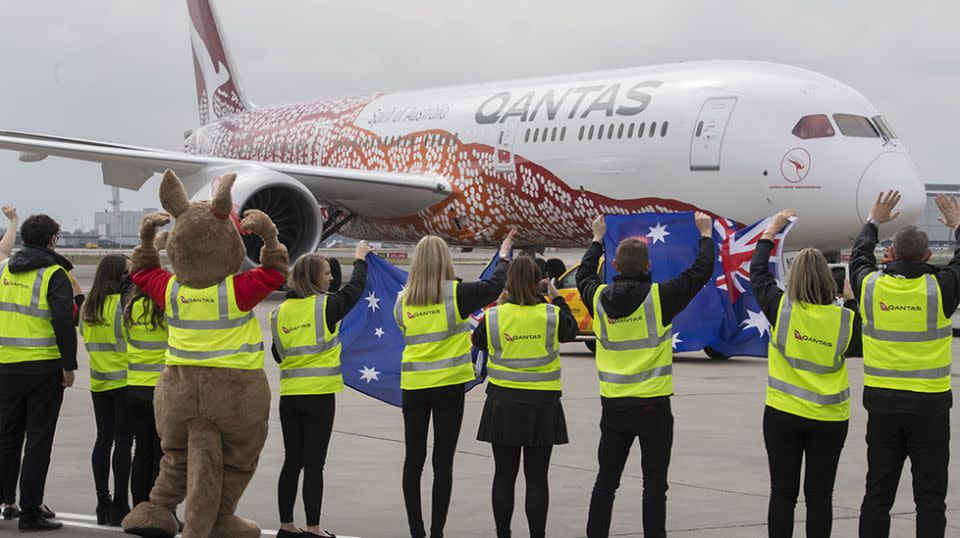 Qantas staff wave goodbye to flight QF10 as she leaves the gate from Heathrow en route to Perth. Source: Getty