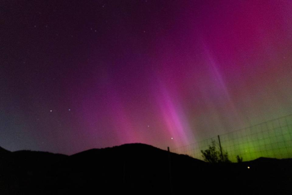 The northern lights appear north of Lucky Peak State Park near Boise, Friday, May 10, 2024. The phenomenon was made possible by a large solar storm interacting with the Earth’s magnetic field, creating glowing atmospheric gases.