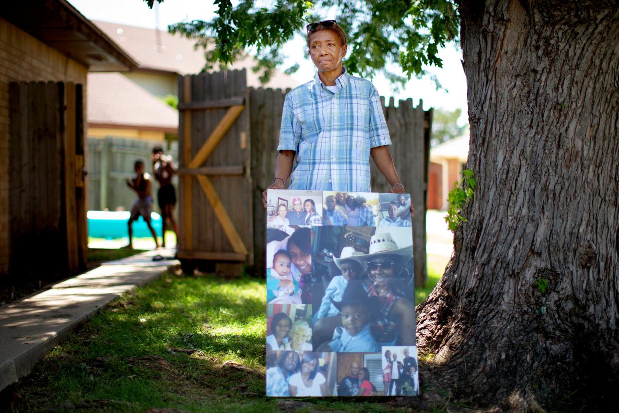 Connie Basco holds photos of her daughter, Star Shells, as Shells' sons play in the background Thursday, June 16, 2022, outside Basco's Oklahoma City home. Star Shells was pregnant when a stolen truck, being pursued by Oklahoma City police, collided with her car in May 2021.